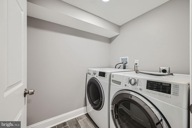 clothes washing area featuring separate washer and dryer