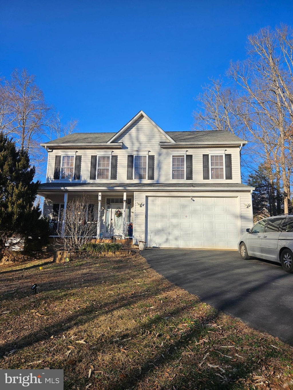 view of front of house with a porch and a garage