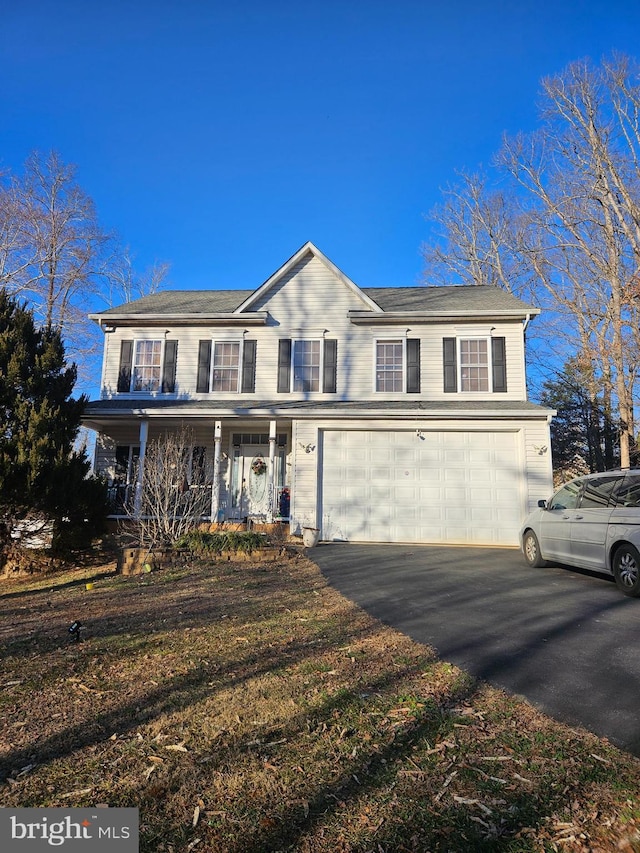 view of front of home featuring a garage, a porch, and aphalt driveway