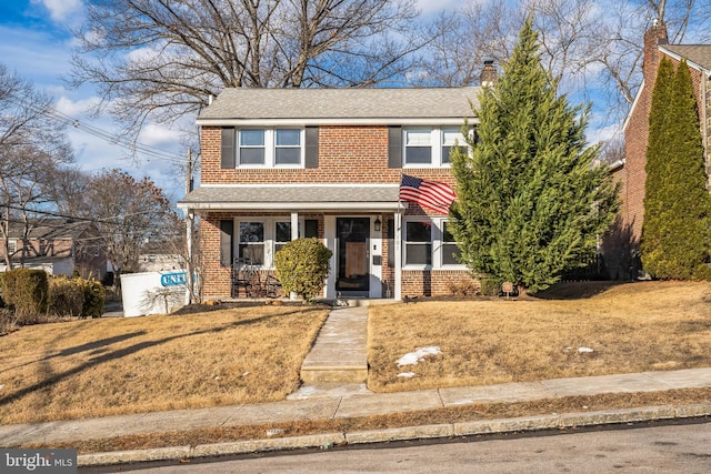 front of property with covered porch and a front lawn