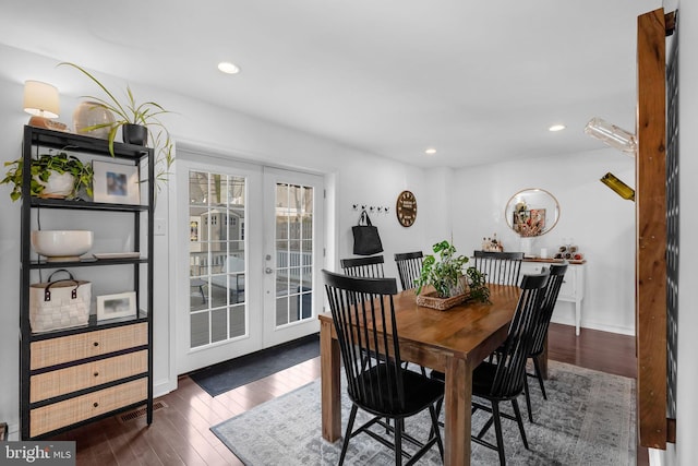 dining space with dark wood-type flooring and french doors