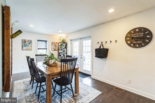 dining area with a healthy amount of sunlight, dark hardwood / wood-style floors, and french doors