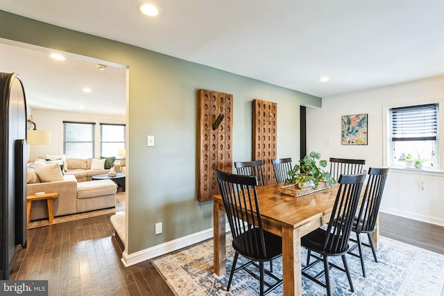 dining area with dark hardwood / wood-style flooring and a wealth of natural light