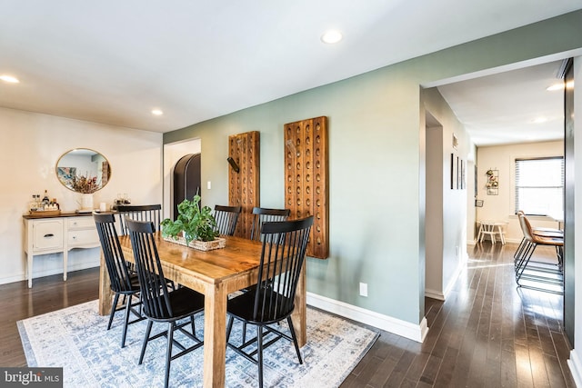 dining space with dark wood-type flooring