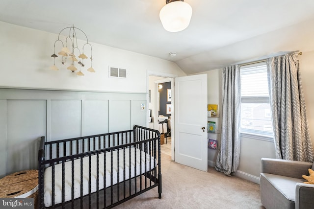 bedroom featuring lofted ceiling and light carpet