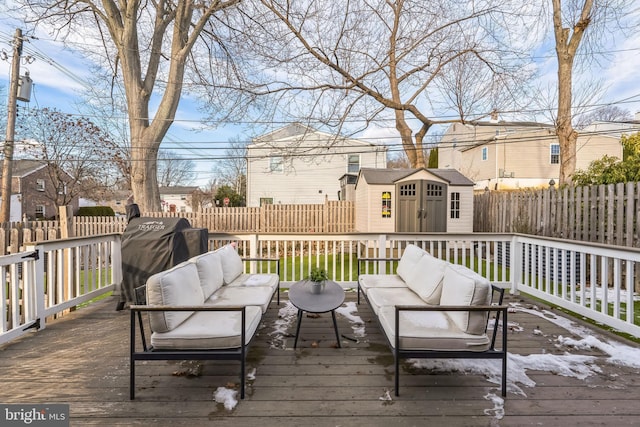 wooden deck featuring a storage shed and an outdoor hangout area