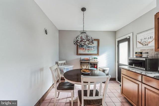 dining area with light tile patterned floors