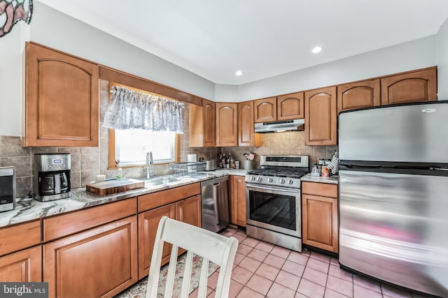 kitchen with stainless steel appliances, sink, light tile patterned floors, and decorative backsplash