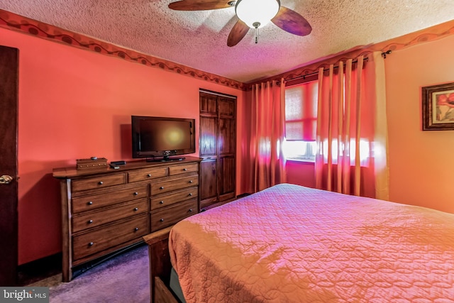 carpeted bedroom featuring ceiling fan, a closet, and a textured ceiling