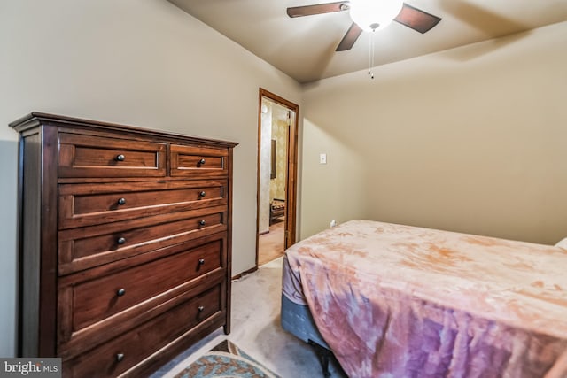 bedroom with ceiling fan and light carpet