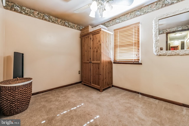 unfurnished room featuring ceiling fan and light colored carpet