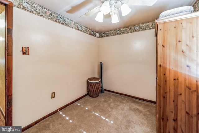 carpeted empty room featuring ceiling fan