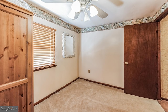 unfurnished room with light carpet and ceiling fan