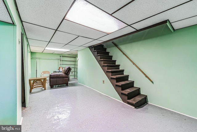 basement with a paneled ceiling