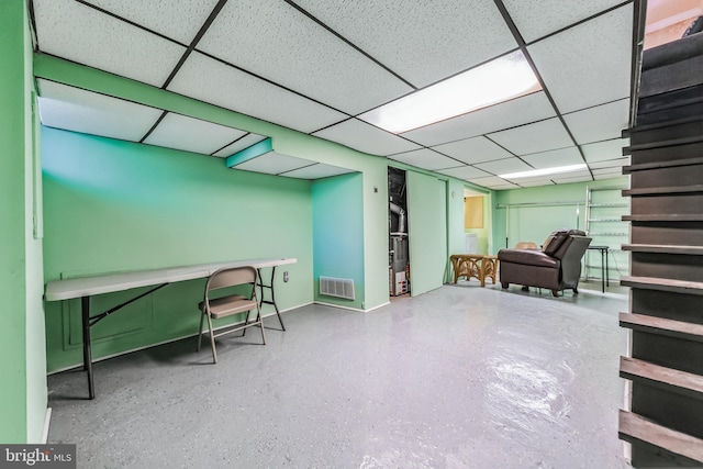 basement with a paneled ceiling