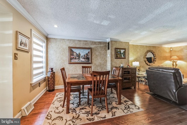 dining area with crown molding, wood-type flooring, and a textured ceiling