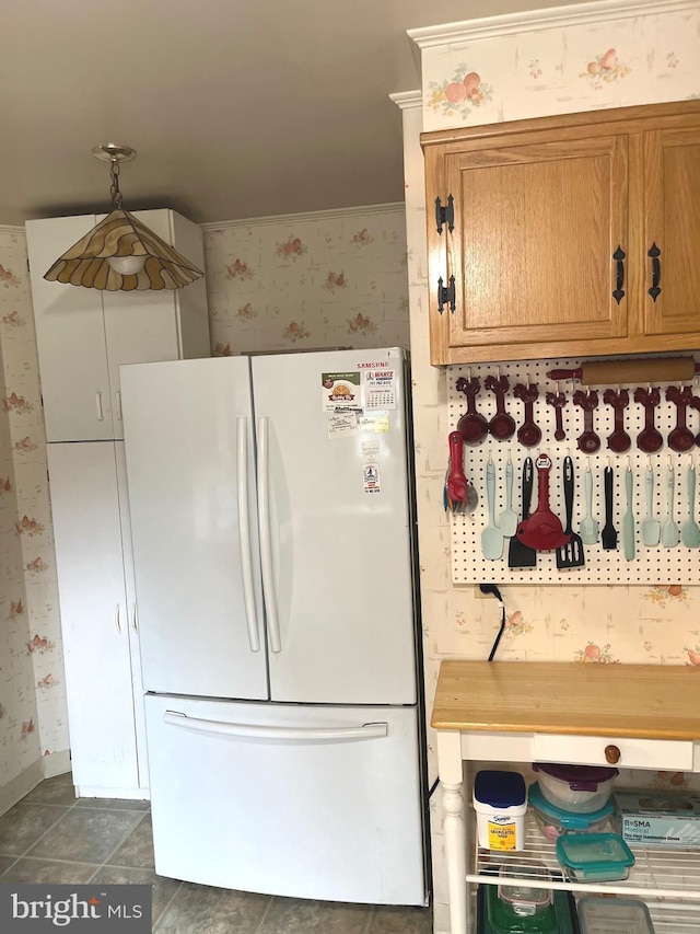 kitchen with white fridge and pendant lighting