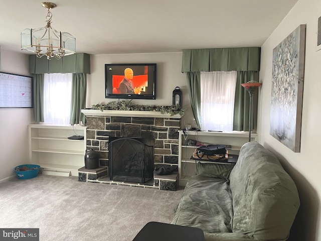 carpeted living room featuring an inviting chandelier and a fireplace