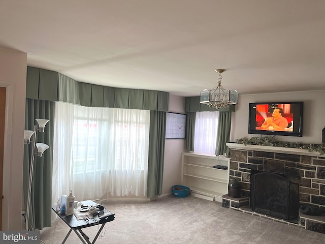 carpeted living room with an inviting chandelier and a fireplace