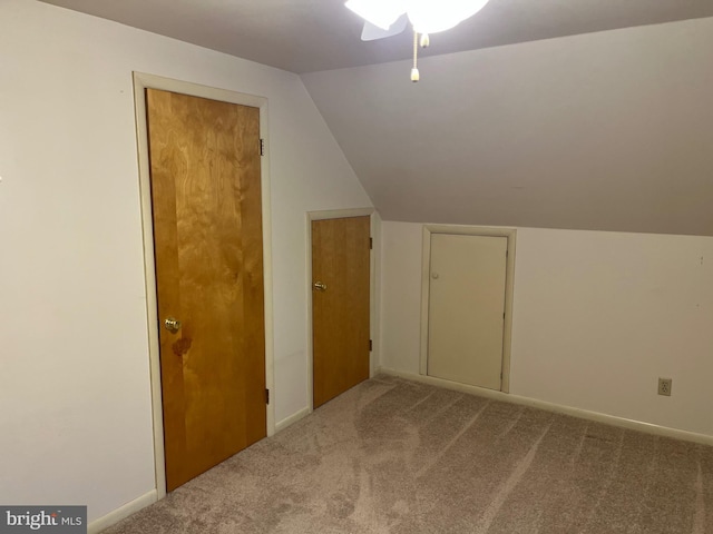 additional living space with carpet flooring and vaulted ceiling