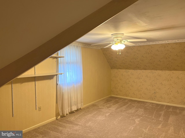 additional living space with lofted ceiling, ceiling fan, and carpet flooring