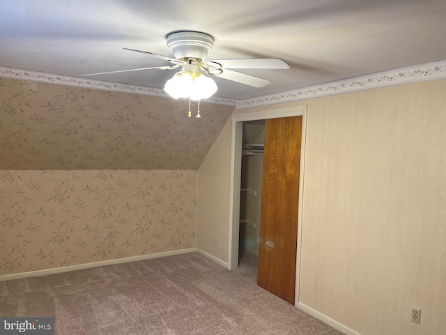 bonus room with lofted ceiling, ceiling fan, and carpet