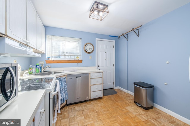 washroom with sink, cabinets, and light parquet floors