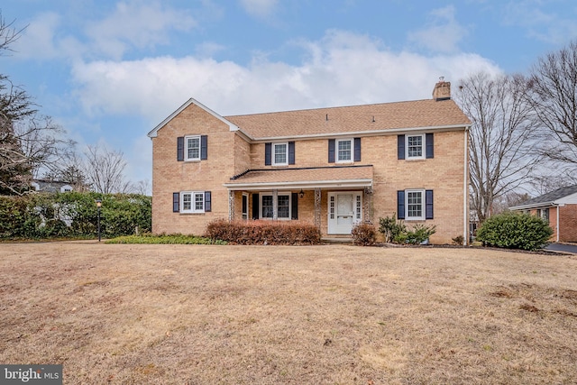 view of front of house with a porch and a front lawn