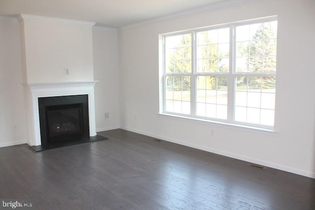 unfurnished living room featuring ornamental molding and dark hardwood / wood-style flooring