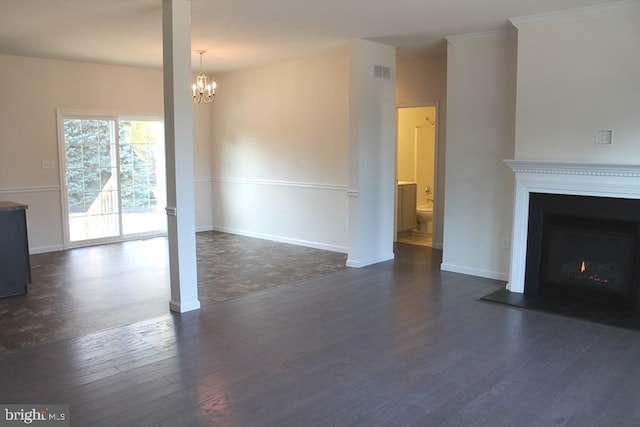 unfurnished living room with dark hardwood / wood-style floors and an inviting chandelier