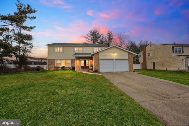 traditional home featuring driveway, a garage, a lawn, fence, and brick siding