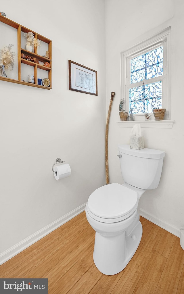 bathroom with toilet and hardwood / wood-style floors