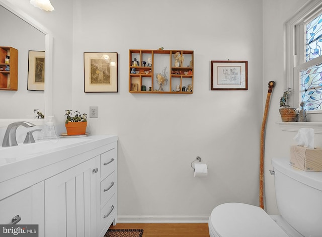 bathroom with vanity, hardwood / wood-style floors, and toilet