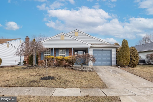 single story home with a garage, central AC, and a front yard