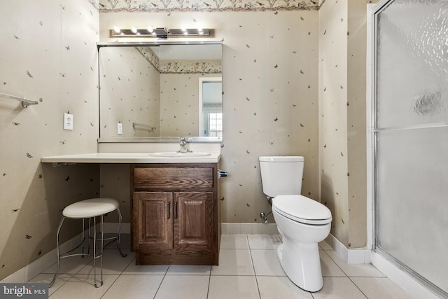 bathroom featuring tile patterned flooring, vanity, and toilet