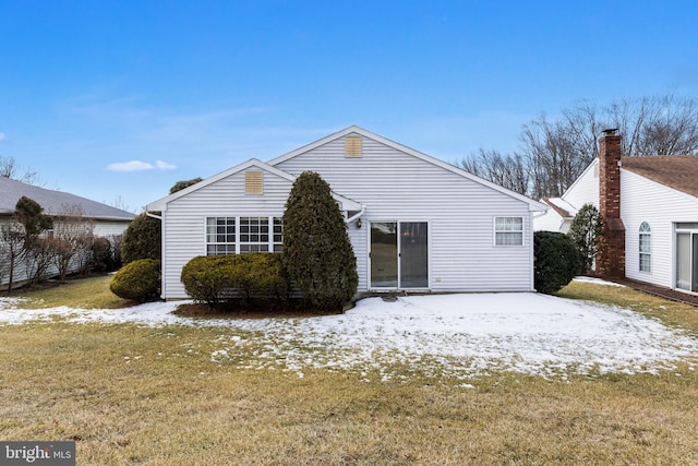 snow covered property featuring a yard