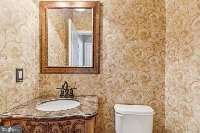 bathroom featuring vanity and toilet