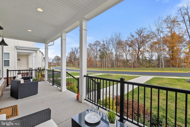 exterior space with covered porch and a lawn