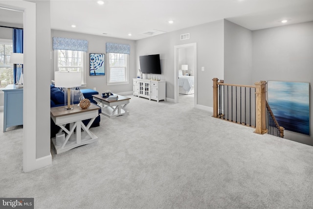 carpeted living room with washer / dryer