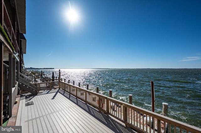 wooden terrace featuring a water view and a dock