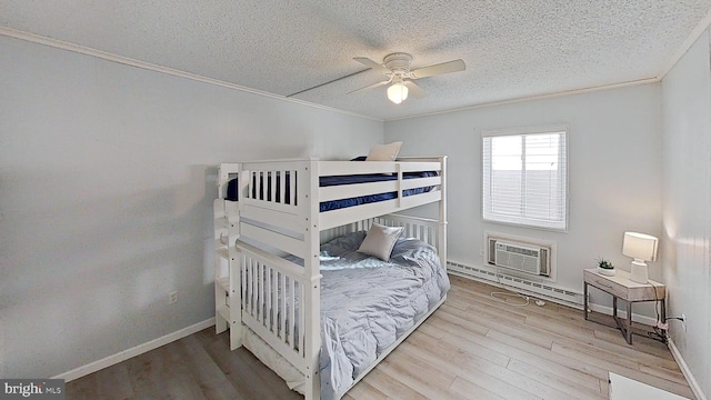 bedroom featuring light hardwood / wood-style flooring, ornamental molding, and ceiling fan