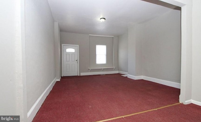 view of carpeted foyer entrance