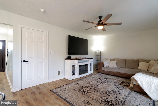 living room with hardwood / wood-style flooring and ceiling fan