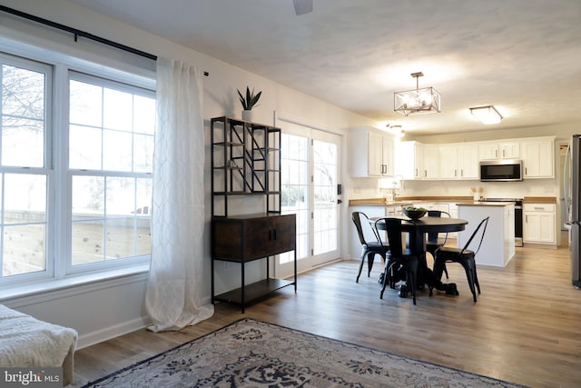 dining space featuring sink and light wood-type flooring