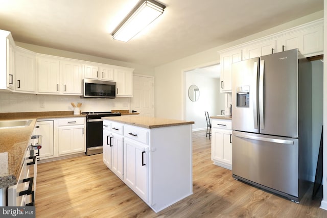 kitchen featuring stainless steel appliances and white cabinets