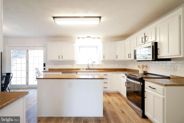 kitchen featuring white cabinetry and appliances with stainless steel finishes