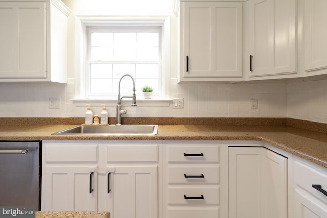 kitchen with dishwasher, sink, and white cabinets