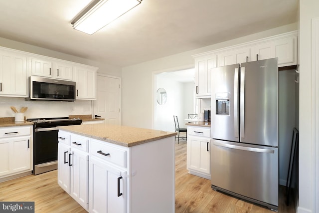 kitchen featuring white cabinetry, appliances with stainless steel finishes, and light hardwood / wood-style flooring