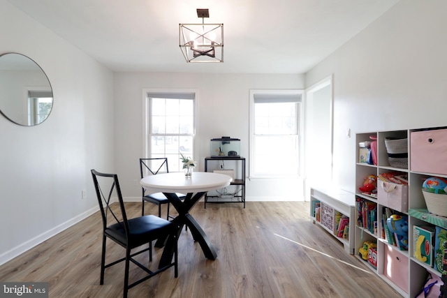 dining area with a notable chandelier and wood-type flooring