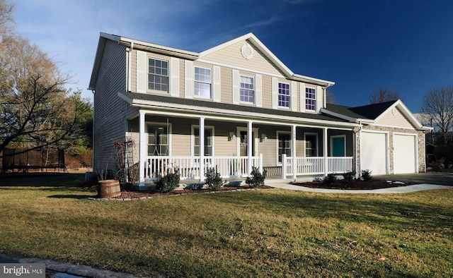 view of front of property featuring a garage, a front yard, and covered porch